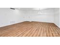 Spacious living room with hardwood floors, contemporary light fixture, and neutral paint at 1300 Queens Rd # 405, Charlotte, NC 28207