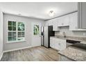 Eat-in kitchen with granite countertops, stainless steel appliances, ample windows and wood-look floors at 14658 Laura Michelle Rd, Huntersville, NC 28078