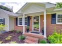 Inviting front porch with brick steps and columns, framed by lush landscaping at 1498 Legion Rd, Fort Mill, SC 29715