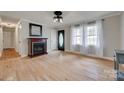 Bright living room with hardwood floors, a cozy fireplace, and ample natural light at 1498 Legion Rd, Fort Mill, SC 29715