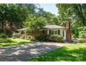 Brick home featuring mature trees, lush landscaping, and lengthy driveway at 2008 Kimway Dr, Matthews, NC 28105