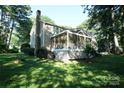 Exterior view of a home with a screened porch, chimney and lush landscaping at 2087 Poinsett Dr, Rock Hill, SC 29732