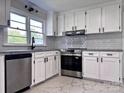 Bright kitchen features white cabinets, subway tile backsplash, stainless steel appliances, and granite countertops at 218 Hartman St, Gastonia, NC 28052