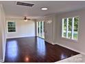 Spacious living room featuring beautiful hardwood floors and large windows providing ample natural light at 218 Hartman St, Gastonia, NC 28052