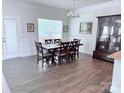 Bright dining room with wood floors, a large window, and a classic wood china cabinet at 231 Glenwood Dr # 4, Oakboro, NC 28129