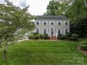 Two-story home with well-maintained lawn, complemented by lush green landscaping and mature trees at 2410 Monticello Dr, Gastonia, NC 28056
