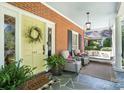 Charming front porch with seating area and a porch swing that invites relaxation at 307 Dogwood Dr, Mount Holly, NC 28120