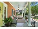Inviting front porch with slate flooring, comfortable seating, and a classic porch swing at 307 Dogwood Dr, Mount Holly, NC 28120
