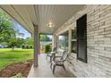 Inviting front porch with brick accents, features two chairs, and offers relaxing outdoor space at 310 25Th Nw Ave, Hickory, NC 28601