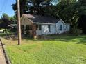 Exterior view of home featuring a quaint yard and older construction at 310 E Division Ave, East Spencer, NC 28039