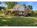 Charming two-story home with beautiful landscaping, manicured lawn, brick facade, and bright white trim at 322 Oakview Dr, Salisbury, NC 28146