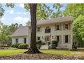 Attractive two-story white brick home displaying a lush lawn, tidy landscaping, and inviting entrance at 3717 Bounty Ct, Matthews, NC 28104