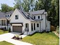 Charming two-story home features a modern farmhouse design and well-manicured lawn at 3953 Plainview Rd, Charlotte, NC 28208