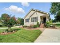 Well-maintained home with lush lawn, landscaped beds, and charming curb appeal at 402 Walnut St, China Grove, NC 28023