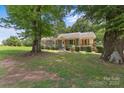 Inviting home exterior with a well-manicured lawn, mature trees, and charming curb appeal at 435 Stirewalt Rd, China Grove, NC 28023