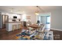 Bright, updated kitchen with stainless steel appliances, wood countertops, and an open dining area with an accent rug at 4429 Dawnwood Dr, Gastonia, NC 28056
