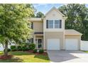 Charming two-story home featuring a two-car garage, well-maintained lawn and manicured landscaping at 523 Smokehouse Ln, Albemarle, NC 28001