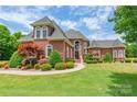 Stately brick home boasting manicured landscaping and classic architectural details at 572 W Shiloh Unity Rd, Lancaster, SC 29720