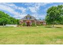 Beautiful brick home with a sprawling lawn and meticulously maintained landscaping at 572 W Shiloh Unity Rd, Lancaster, SC 29720
