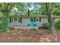 Charming single story exterior features a blue front door, brick accents, and a well-kept lawn at 5914 Mt Holly Huntersville Rd, Charlotte, NC 28216