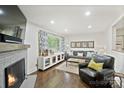 Bright living room offers hardwood floors, a cozy fireplace, and neutral decor for a modern feel at 5914 Mt Holly Huntersville Rd, Charlotte, NC 28216