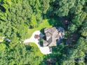 Expansive property showcasing lush landscaping and a circular driveway enhancing the home's curb appeal at 5955 Mountain Point Ln, Charlotte, NC 28216