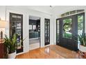 Bright foyer with hardwood floors, glass doors, and views into the adjacent rooms at 606 Vega Nw St, Concord, NC 28027