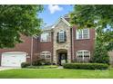 Charming brick home with stone accents, a well-manicured lawn, and beautiful landscaping at 606 Vega Nw St, Concord, NC 28027