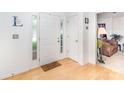 Bright entryway featuring hardwood floors, white walls, and a welcoming front door with sidelights at 6619 Bittinger Ct, Charlotte, NC 28216