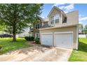 Two-story home boasts a two-car garage, well-maintained lawn, and neutral siding under a cloudy sky at 6619 Bittinger Ct, Charlotte, NC 28216