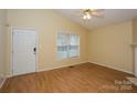 Inviting living room features bright neutral walls, wood floors, and a large window for natural light at 828 Saint Andrews Pl, Concord, NC 28025