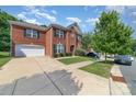 Beautiful brick home with a well-maintained lawn, mature trees, and a spacious driveway at 9807 Maywine Cir, Huntersville, NC 28078