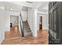 Spacious foyer featuring hardwood floors, staircase, and elegant architectural details at 1011 Wadsworth Ln, Indian Trail, NC 28079