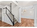 Inviting foyer with hardwood floors, staircase, and view into a dining room with chandelier at 1011 Wadsworth Ln, Indian Trail, NC 28079