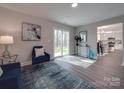 Well-lit living room with access to the outdoors and a view of the kitchen at 1016 Forest Dr, Marshville, NC 28103