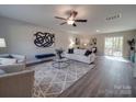 Bright living room featuring neutral walls, modern furnishings, and a ceiling fan at 1016 Forest Dr, Marshville, NC 28103