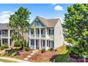Two-story home with a welcoming front porch and classic architectural details at 10509 Serape Rd, Charlotte, NC 28277