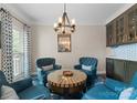 Inviting sitting area with comfortable seating, a stylish table, and elegant decor at 112 Steeplechase Ave, Mooresville, NC 28117