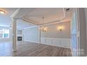 Spacious dining room with elegant lighting, crown molding, and wood floors at 11514 Hattie Little St, Charlotte, NC 28269