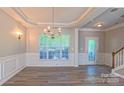 Bright living room featuring elegant lighting, crown molding, and wood floors at 11514 Hattie Little St, Charlotte, NC 28269