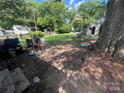Backyard with green grass, trees, and storage shed at 119 Hemlock Ave, Kannapolis, NC 28081