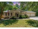 Charming single-story home with an inviting front porch, manicured lawn, and a convenient two-car garage at 124 Julius Ln, Mooresville, NC 28117