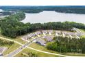 Aerial view of lakeside community featuring beautiful homes, mature trees and lake access at 1300 Dali Blvd, Mount Holly, NC 28120