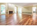 Spacious living room with hardwood floors, fireplace, and arched windows that offer lots of natural light at 13037 Angel Oak Dr, Huntersville, NC 28078