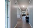 Bright hallway featuring an arched entrance, clean gray walls, and modern wood-look floors at 1324 Mona Vale Dr, Huntersville, NC 28078