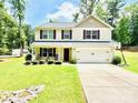Charming two-story home with a well-kept lawn, seating on the porch, and a convenient two-car garage at 1528 Magnolia Dr # 8, Lancaster, SC 29720