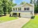 Attractive two-story home features a two-car garage, well-maintained lawn, and a driveway with a basketball hoop at 1528 Magnolia Dr # 8, Lancaster, SC 29720