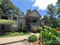 Inviting condo featuring a covered entrance, well-maintained landscaping, and plenty of natural light at 1590 Springpoint Rd # B, Rock Hill, SC 29732