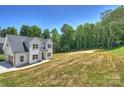 New two-story home with lush surroundings offering a blend of modern living and natural serenity in a picturesque setting at 164 Meadow Glen Dr, Troutman, NC 28166