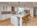 Bright kitchen with large island, granite countertops, stainless steel appliances, and hardwood floors at 202 Walden Ln, Weddington, NC 28104